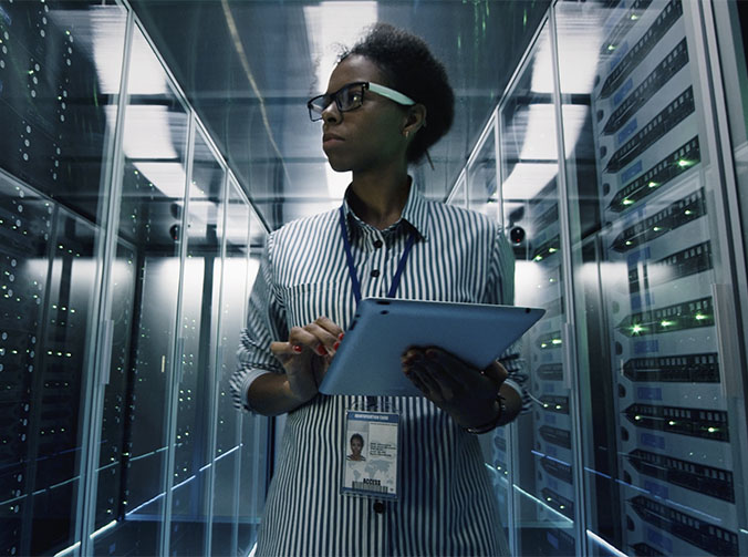 A woman working in a server room