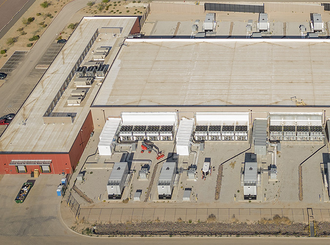 An aerial shot of a data center building with reflective roof