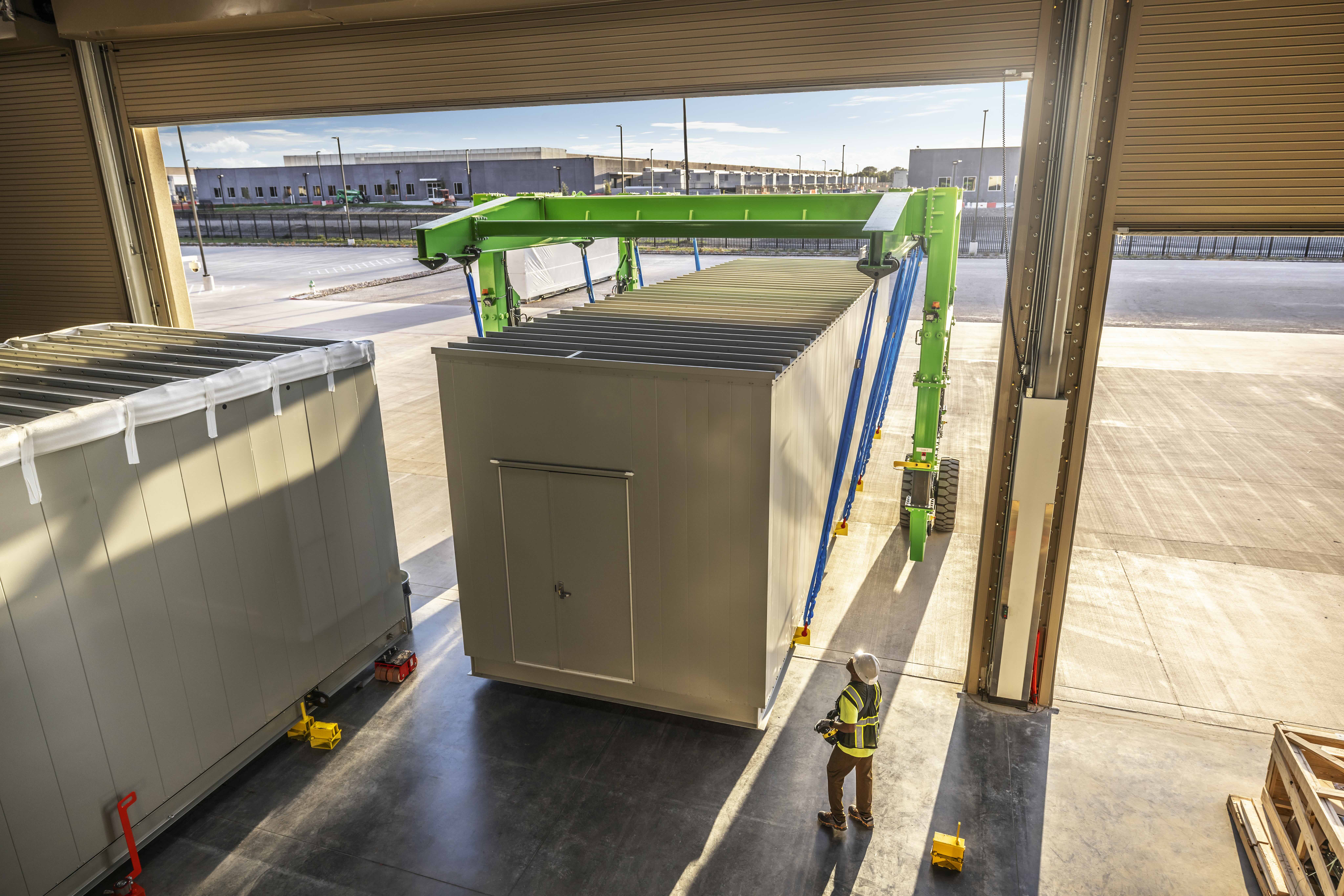 Large prefabricated module being positioned inside a building during installation.